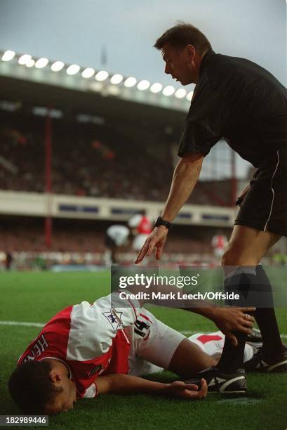 Premiership Football - Arsenal v Tottenham Hotspur, Referee Halsey stops play as he attends to Thierry Henry who had sustained a serious looking...