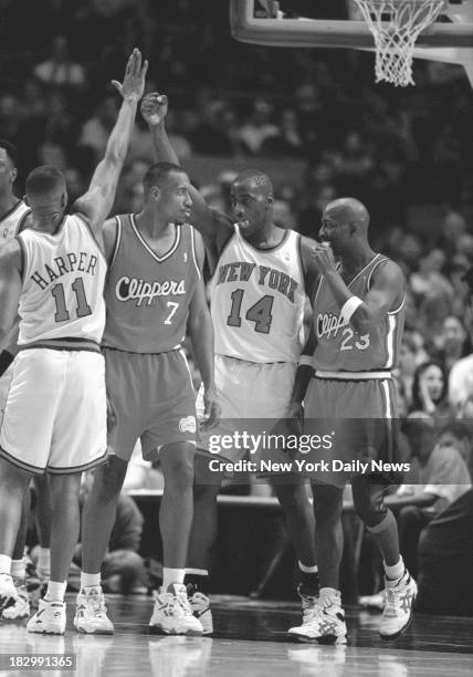 Knicks vs. Clippers - Knicks Derek Harper and Anthony Mason high five over Clippers Lamond Murray, Gary Grant of Clippers looks on.