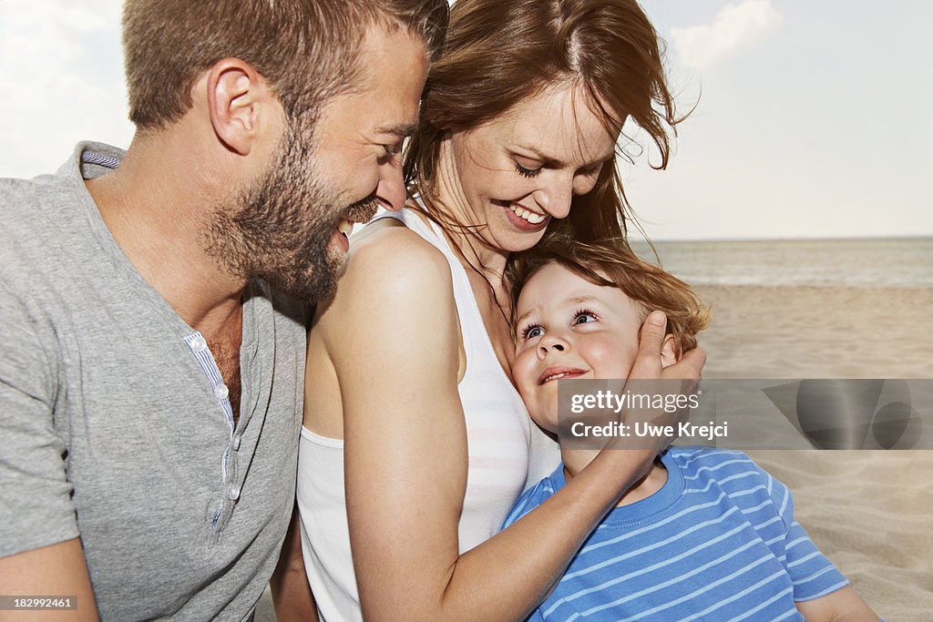 Happy family on the beach, close up