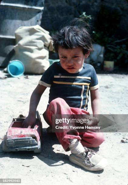 Little boy, alone with his brother at home, plays outside his house September 4, 1982 in Santa Catarina, Mexico. Poverty is prevalent in Santa...