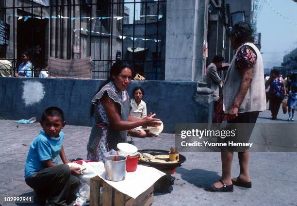 Woman cooks and sells tortillas in the street September 4, 1982 in Mexico City, Mexico.