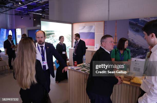 Conference participants chat in the Russian Federation pavilion on day five of the UNFCCC COP28 Climate Conference at Expo City Dubai on December 04,...