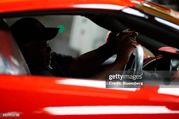 Worker checks the interior of a 2014 Chevrolet Corvette Stingray at the General Motors Co. Bowling Green Assembly Plant in Bowling Green, Kentucky,...