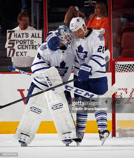 Jonathan Bernier and Colton Orr of the Toronto Maple Leafs embrace after defeating the Philadelphia Flyers at the Wells Fargo Center on October 2,...