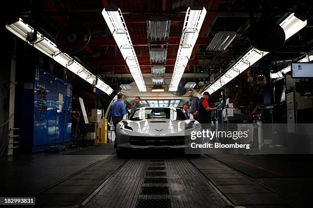 Workers inspect a 2014 Chevrolet Corvette Stingray at the General Motors Co. Bowling Green Assembly Plant in Bowling Green, Kentucky, U.S., on...