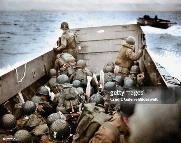 Landing Craft, Vehicle, Personnel is approaching Omaha Beach, Normandy, France, 6th June 1944. To the right is another LCVP. The soldiers are...