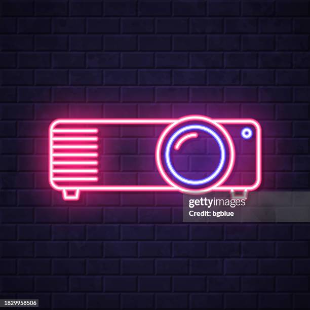 projector. glowing neon icon on brick wall background - overhead projector stock illustrations