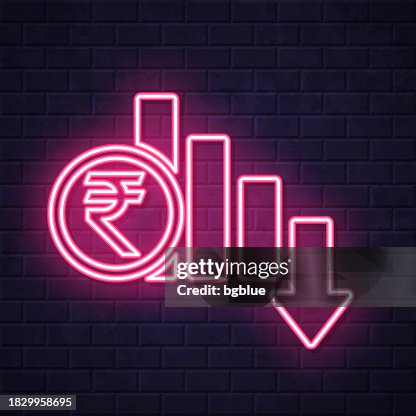 Indian rupee rate decrease. Glowing neon icon on brick wall background Indian rupee rate decrease. Glowing neon icon on brick wall background