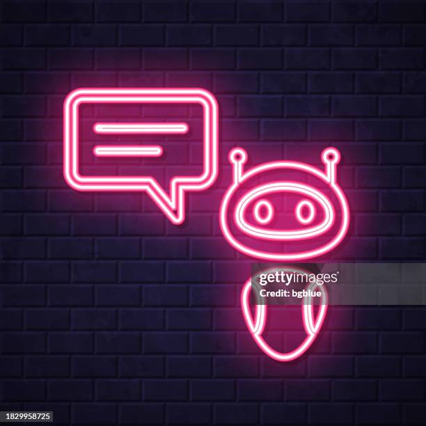 chatbot with speech bubble. glowing neon icon on brick wall background - face lit by computer stock illustrations