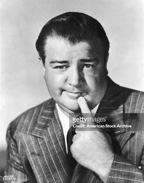 Studio portrait of American comic actor Lou Costello holding his index finger to his chin, 1940s.