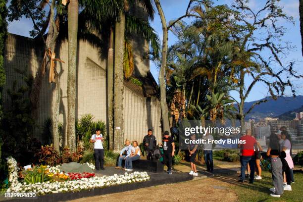 Group of people attend the Pablo Escobar's grave at Jardines Montesacro cementery during 30th anniversary of the late Colombian drug trafficker Pablo...