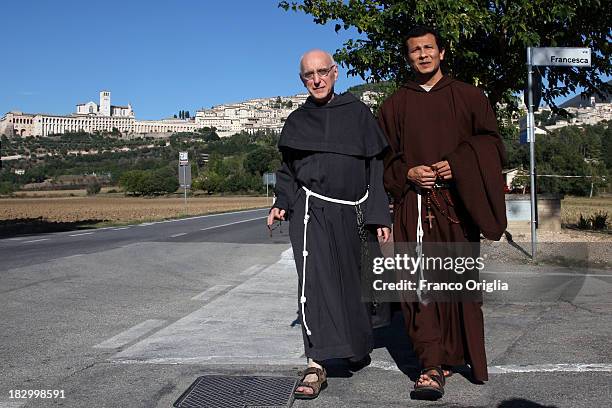 Franciscan friars walk along the road between the towns of Assisi and Santa Maria Degli Angeli prior to Pope Francis' visit on October 3, 2013 in...