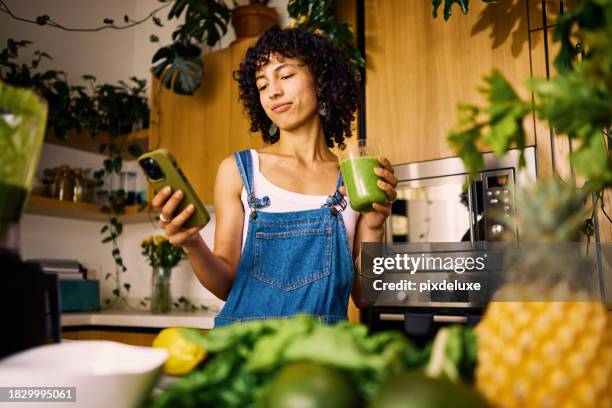stylish home chef researches vitamin rich recipes on mobile for balanced nutrition plan - smoothie bildbanksfoton och bilder