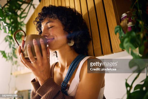 young female at home meditating for a moment with a cup of tea in her hand. mindfulness in the every day. - kitchen fashion stock pictures, royalty-free photos & images