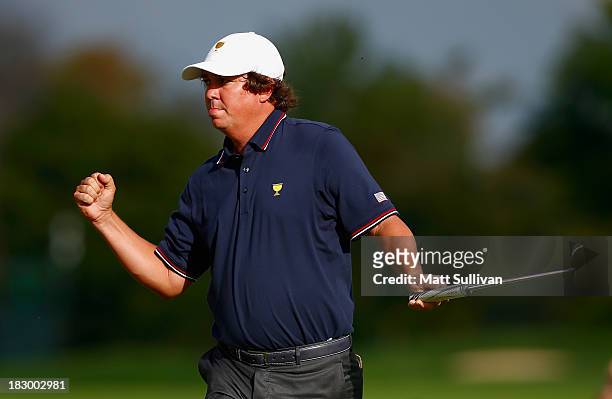Jason Dufner of the U.S. Team makes birdie on the ninth hole during the Day One Four-Ball Matches at the Muirfield Village Golf Club on October 3,...
