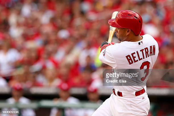 Carlos Beltran of the St. Louis Cardinals hits a three-run home run in the third inning against the Pittsburgh Pirates during Game One of the...