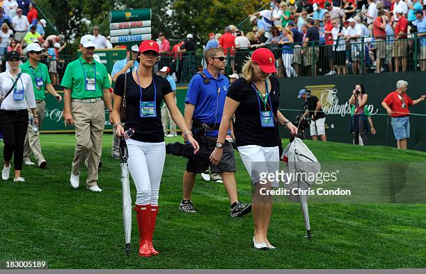 Amanda Dufner and Kim Johnson follow the play of the U.S. Team during the Day One Four-Ball Matches of The Presidents Cup at the Muirfield Village...