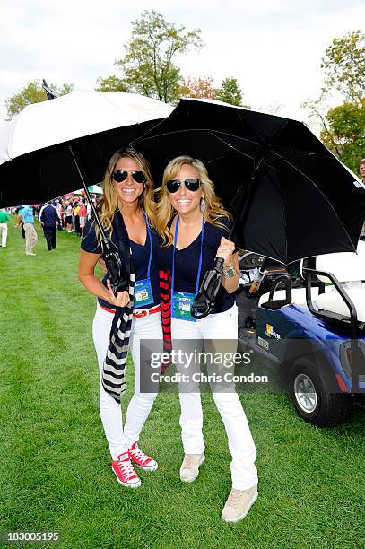 Jillian Stacey and Amy Mickelson follow the play of the U.S. Team during the Day One Four-Ball Matches of The Presidents Cup at the Muirfield Village...