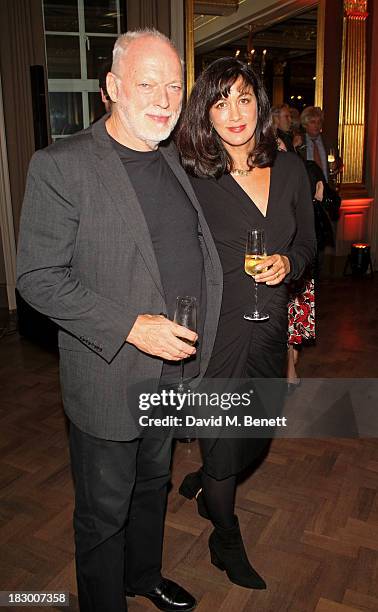 David Gilmour and Polly Samson attend the launch of Geordie Greig's new book "Breakfast With Lucian" on October 3, 2013 in London, England.