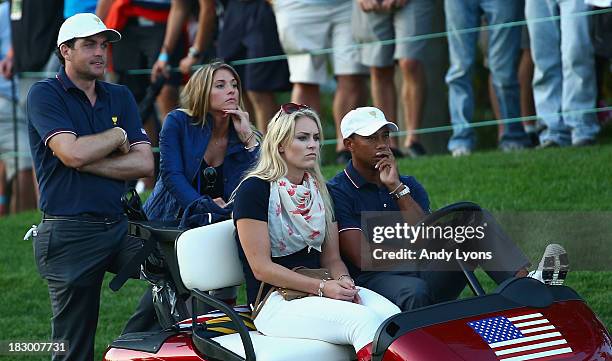 Skiier Lindsey Vonn waits with Tiger Woods alongside Keegan Bradley and Jillian Stacey during the Day One Four-Ball Matches at the Muirfield Village...