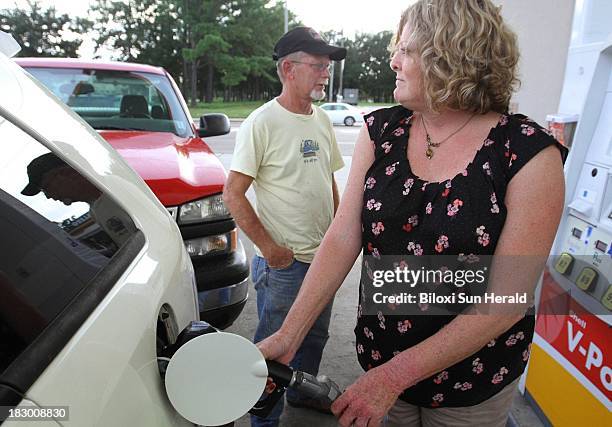 Terry and Clair Canette gas up their car in preparation for Tropical Storm Karen in of Biloxi, Mississippi, on Thursday, October 3, 2013.