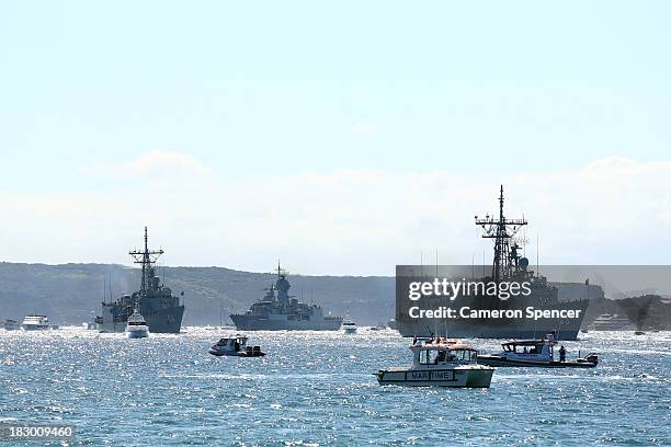 Royal Australian Navy warships HMAS Sydney , HMAS Darwin and HMAS Perth enter Sydney Harbour on October 4, 2013 in Sydney, Australia. Over 50 ships...