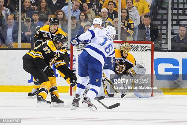 Teddy Purcell of the Tampa Bay Lightning shoots the puck against the Boston Bruins at the TD Garden on October 3, 2013 in Boston, Massachusetts.