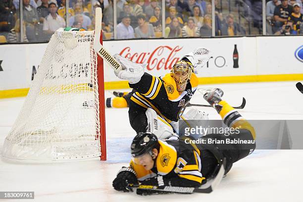 Tuukka Rask of the Boston Bruins misses the puck and lets in a goal against the Tampa Bay Lightning at the TD Garden on October 3, 2013 in Boston,...
