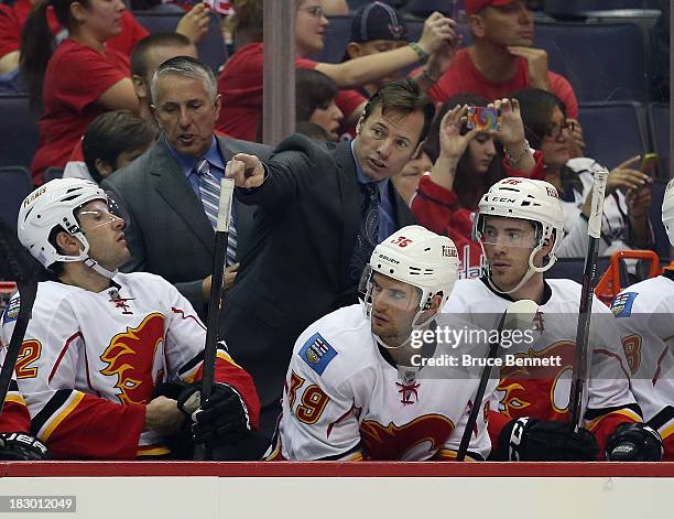 Assistant coach Martin Gelinas of the Calgary Flames gives his players instructions during the third period against the Washington Capitals at the...