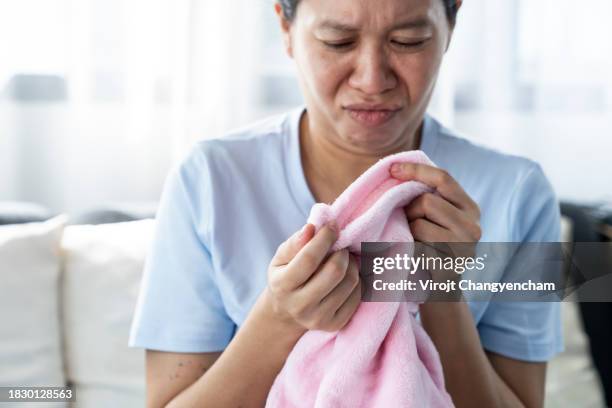 a young woman with clothes that smell musty. - hyperhidrosis stock pictures, royalty-free photos & images