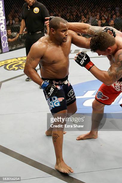 Daniel Cormier punches Frank Mir in their heavyweight bout during the UFC on FOX event at the HP Pavilion on April 20, 2013 in San Jose, California.