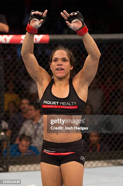 Amanda Nunes celebrates after defeating Sheila Gaff in their women's bantamweight bout during UFC 163 at HSBC Arena on August 3, 2013 in Rio de...