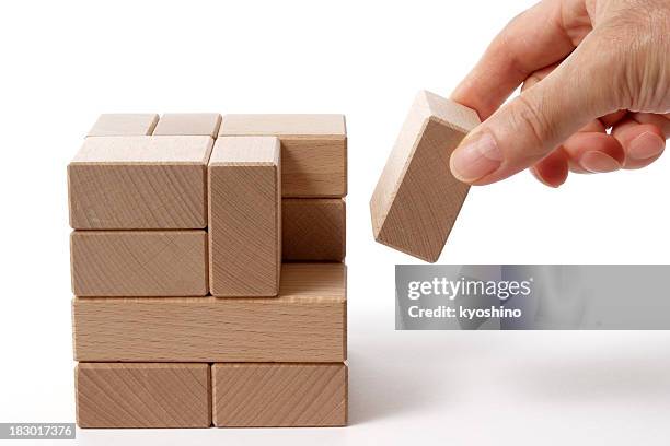 isolated shot of holding a wood block on white background - hands full stock pictures, royalty-free photos & images