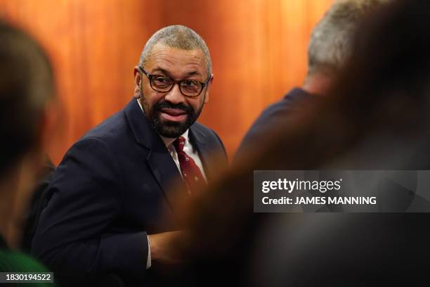 Britain's Foreign Secretary James Cleverly sits in the audience as Britain's Prime Minister Rishi Sunak hosts a press conference inside the Downing...