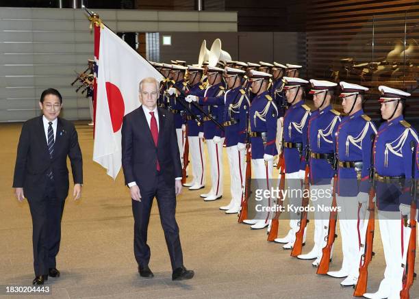Norwegian Prime Minister Jonas Gahr Store walks beside Japanese Prime Minister Fumio Kishida as he receives a guard of honor at the Japanese...