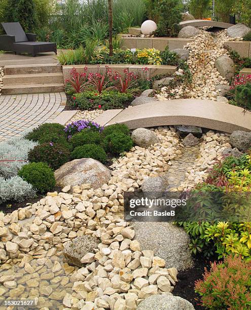 new landscaping with river and bridge - pebble stock pictures, royalty-free photos & images