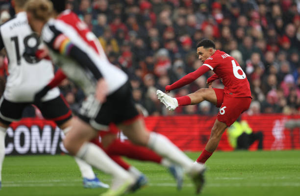 Trent Alexander-Arnold of Liverpool scores the team's first goal from a free kick during the Premier League match between Liverpool FC and Fulham FC...