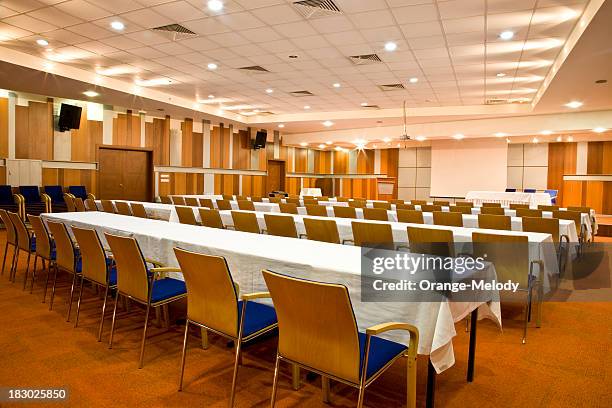 empty conference room with rows of tables and chairs - seminar in rome stock pictures, royalty-free photos & images