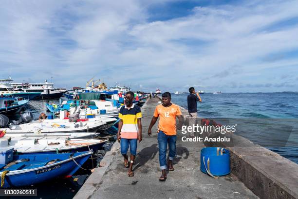 Fisherman drag buckets of fish into the fish market in Male, Maldives on December 05, 2023. Male, is the capital of the Maldives, an island country...