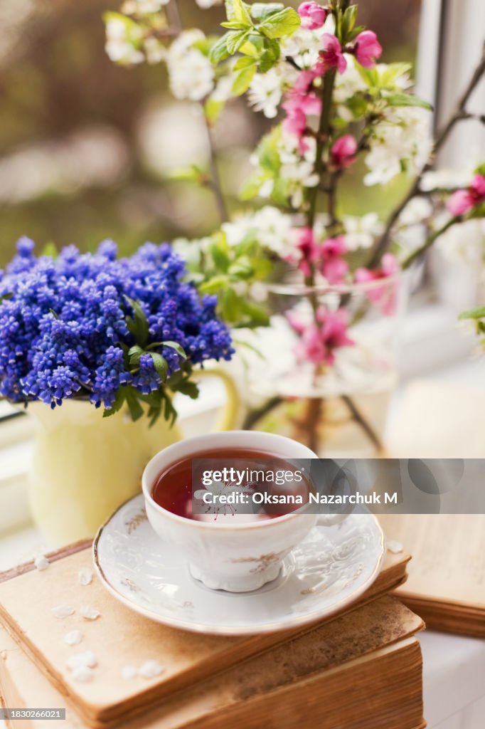 Vintage cup tea near spring flowers