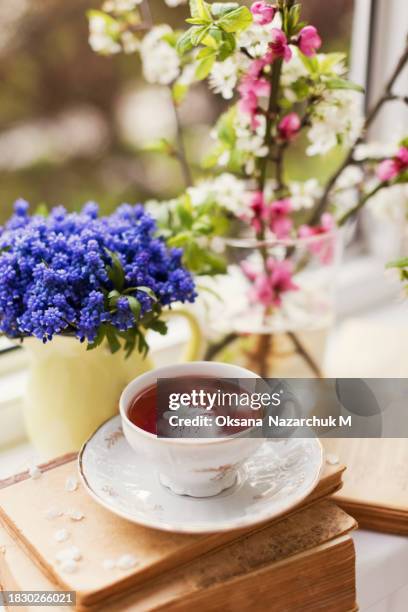 Vintage Cup Tea Near Spring Flowers High-Res Stock Photo
