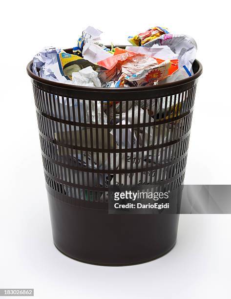 wastepaper basket full of scrunched up paper on white background - wastepaper basket stock pictures, royalty-free photos & images