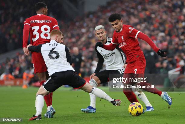 Luis Diaz of Liverpool attempts to move past Harrison Reed of Fulham during the Premier League match between Liverpool FC and Fulham FC at Anfield on...