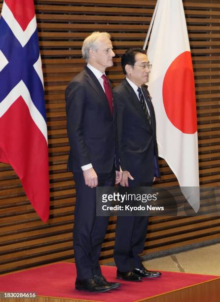 Norwegian Prime Minister Jonas Gahr Store stands beside Japanese Prime Minister Fumio Kishida as he receives a guard of honor at the Japanese...