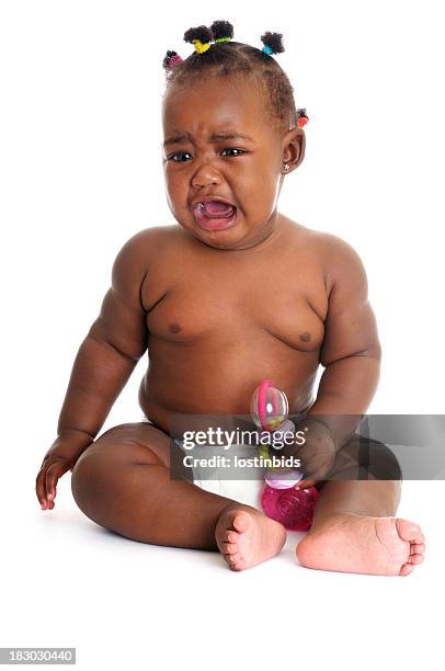 unhappy african american baby girl crying while holding a rattle - fat black girl stock pictures, royalty-free photos & images