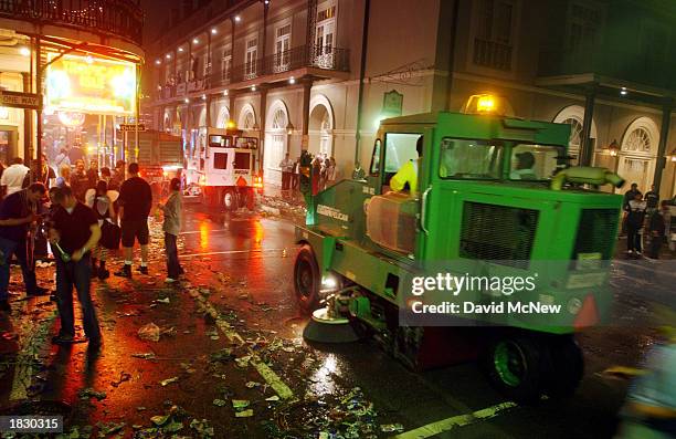 Street sweepers clean up trash left by partiers as Bourbon Street is shut down after the conclusion of Mardi Gras in the early morning hours of March...