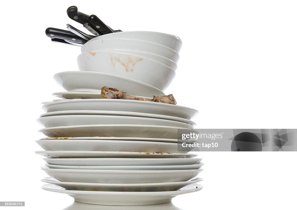 Stack of white dirty dishes on a white background