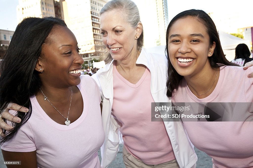 Happy Diverse Group of Women Wearing Pink Laughing Together