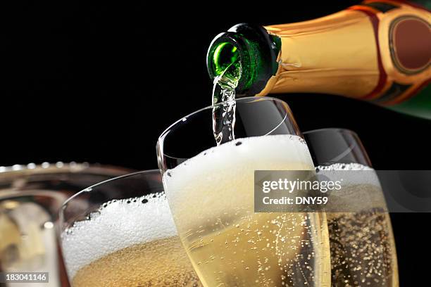 champagne being poured into champagne glasses - bottle stock pictures, royalty-free photos & images