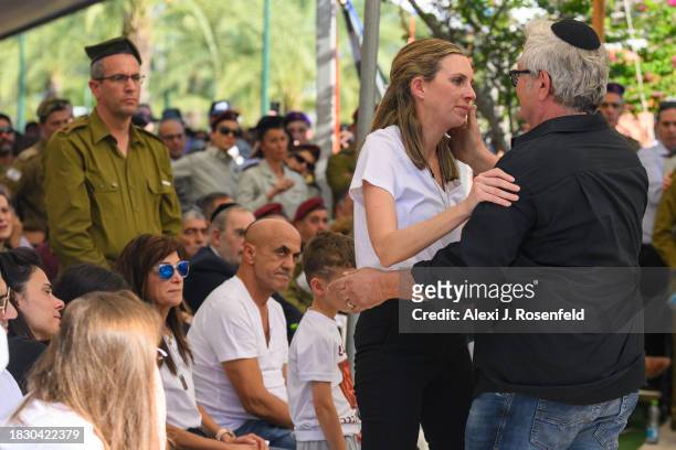 Shlmo Artzi hugs the wife of Col. Asaf Hamami, commander of Gaza Division's Southern Brigade, during his funeral at the Kiryat Shaul cemetery on...